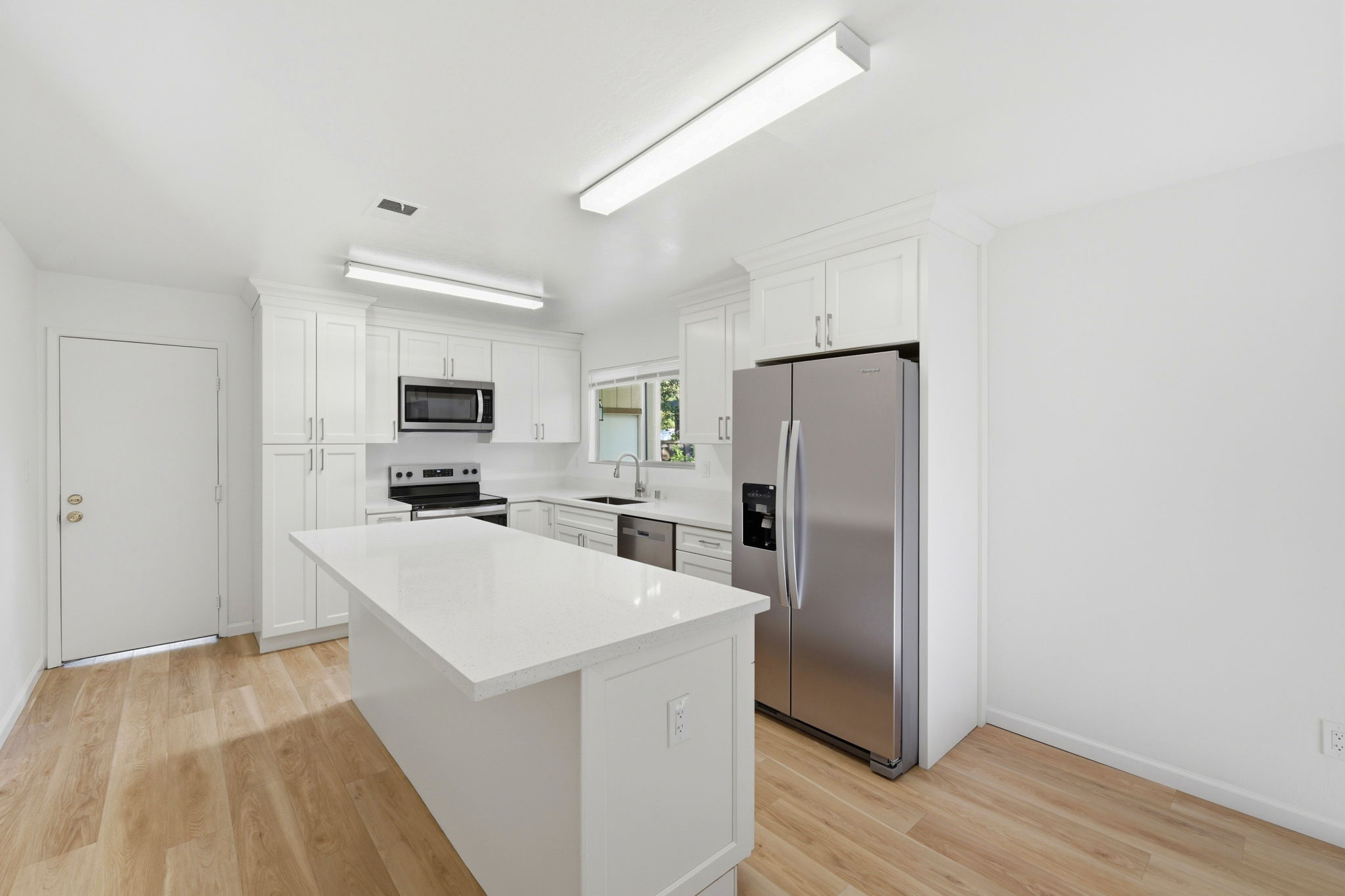 Rebuilt kitchen with a center island in a completed Walnut Creek renovation.