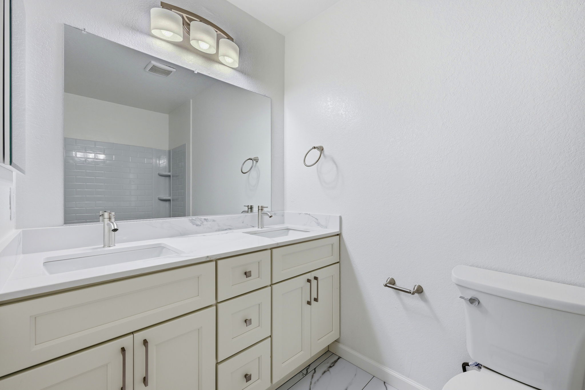 Remodeled bath with double vanity.