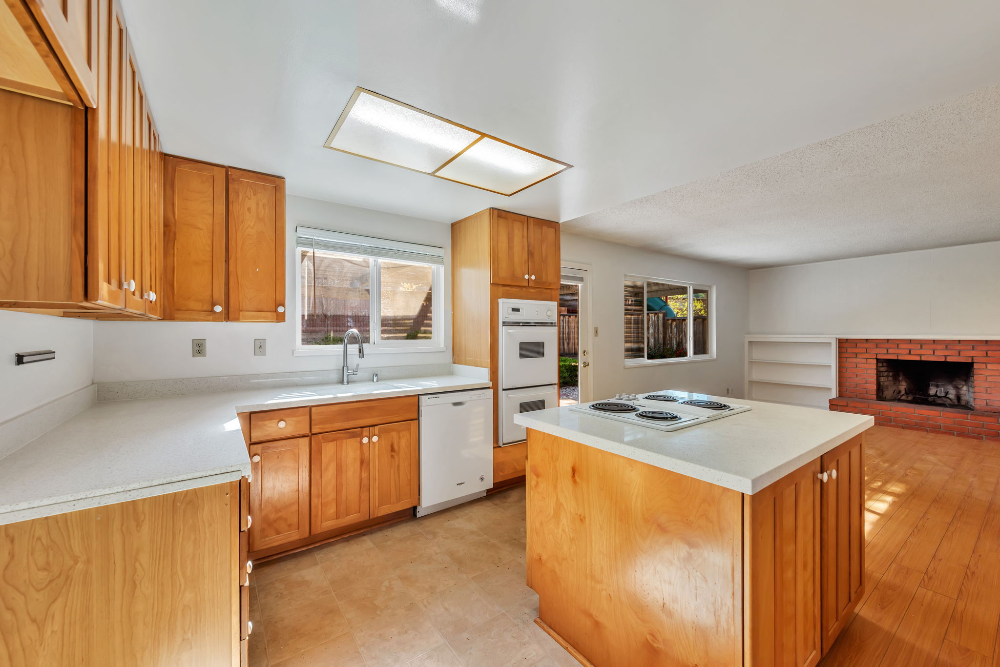 Kitchen after the renovation, with new counters and sink.