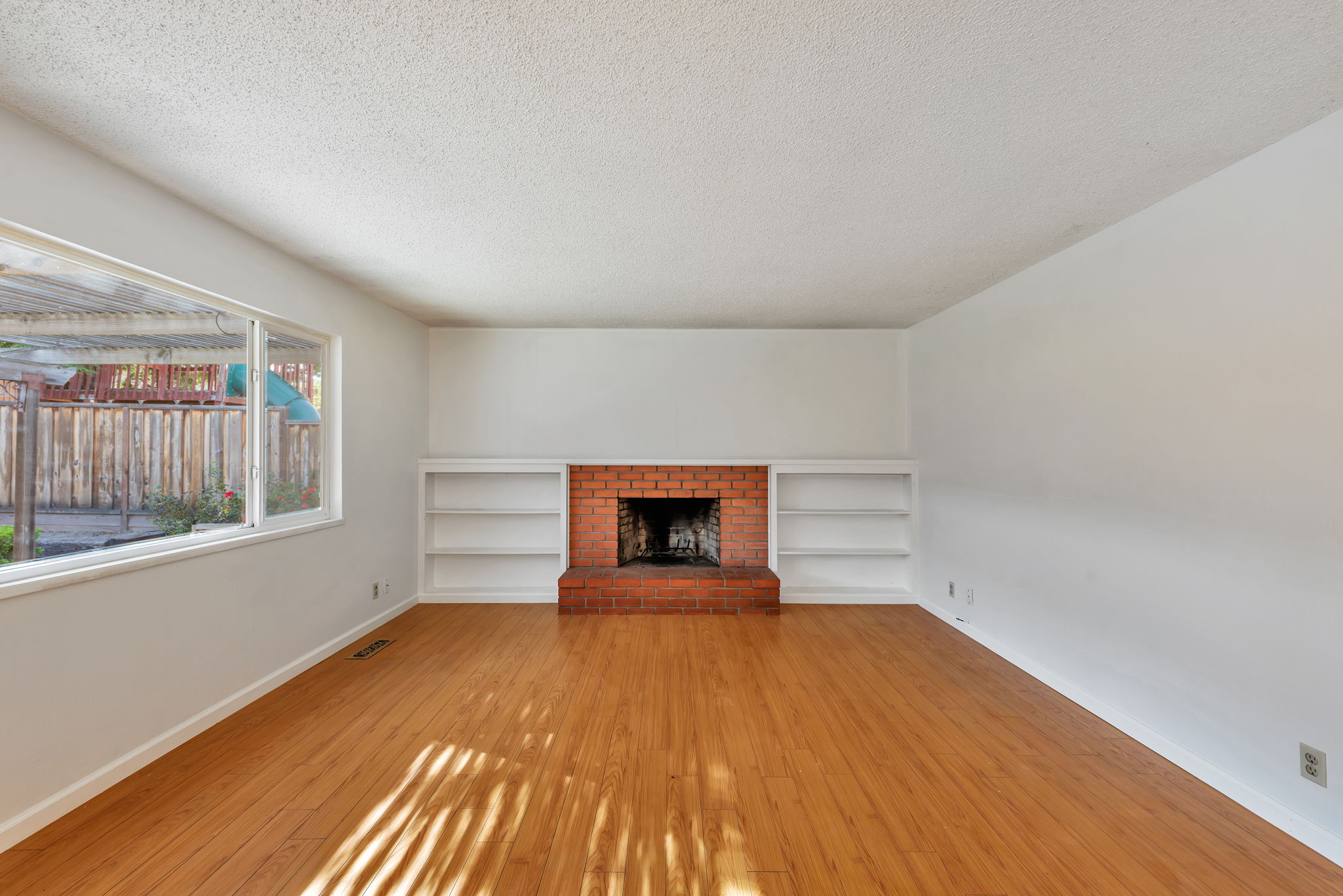 San Ramon living room after the renovation, with refinished hardwood floors.