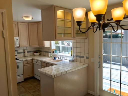 Kitchen before the remodel, with dated cabinets and appliances.